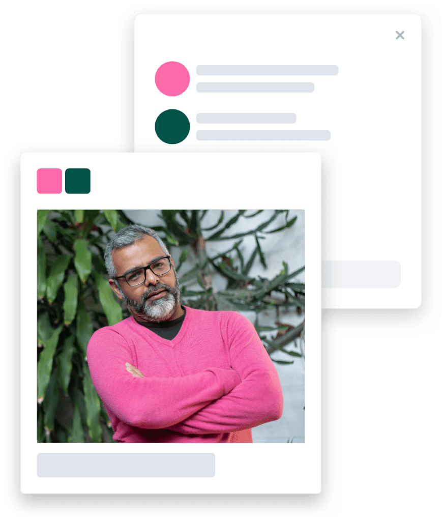 A man with a beard and pink shirt with his arms folded